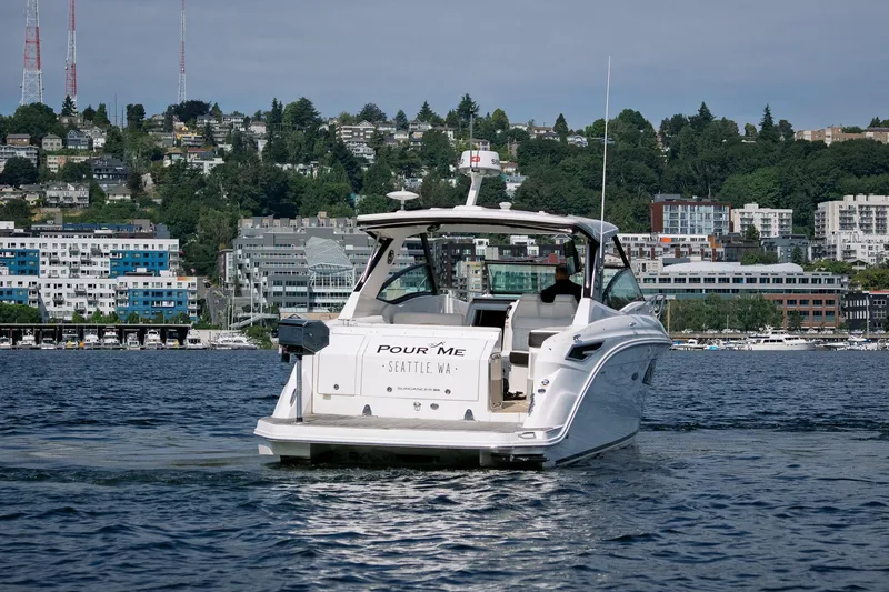  Yacht Photos Pics 2019 Sea Ray Sundancer 320 yacht cruising in Seattle waters with cityscape backdrop.