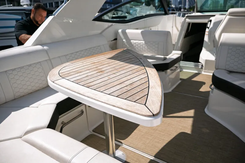  Yacht Photos Pics 2019 Sea Ray Sundancer 320 interior with wooden table and white seating.