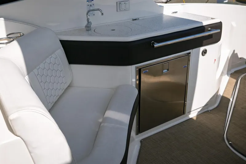  Yacht Photos Pics 2019 Sea Ray Sundancer 320 interior with seating, sink, and stainless steel fridge.