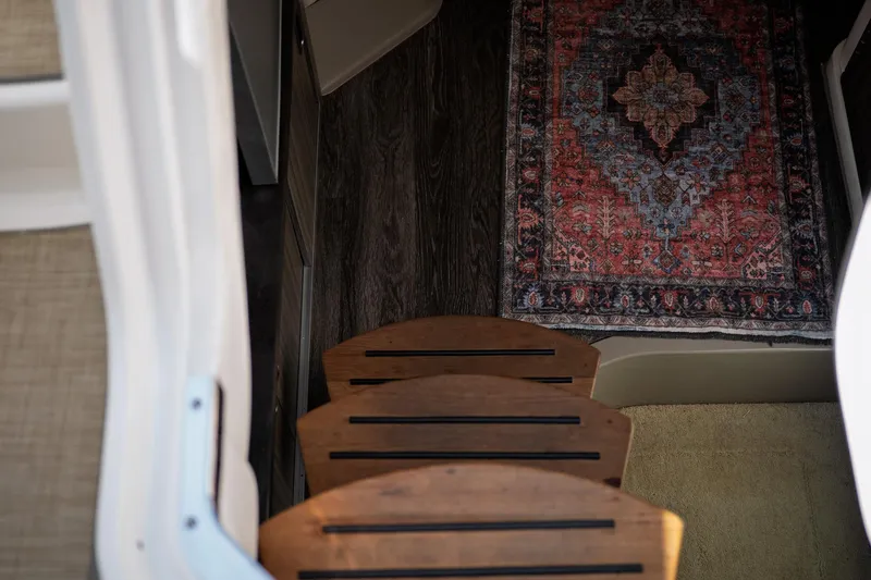  Yacht Photos Pics Interior of 2019 Sea Ray Sundancer 320 with wooden steps and decorative rug.