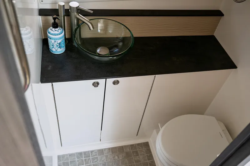  Yacht Photos Pics Luxurious bathroom in 2019 Sea Ray Sundancer 320 yacht with modern glass sink and elegant fixtures.