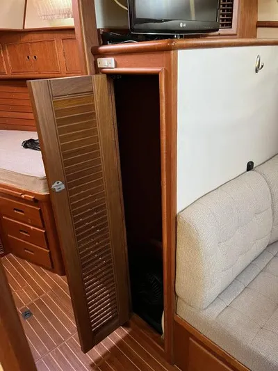 Lio Kai Yacht Photos Pics Interior of 1999 Grand Banks Eastbay 38 with wooden cabinetry and cozy seating.