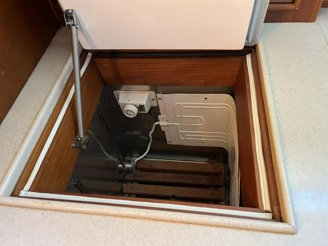 Lio Kai Yacht Photos Pics Storage compartment in 1999 Grand Banks Eastbay 38 yacht, featuring a built-in refrigeration unit.
