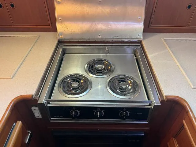 Lio Kai Yacht Photos Pics Stainless steel stove with three burners in a 1999 Grand Banks Eastbay 38 yacht kitchen.
