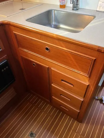 Lio Kai Yacht Photos Pics Wooden kitchen cabinetry with sink in 1999 Grand Banks Eastbay 38 yacht.