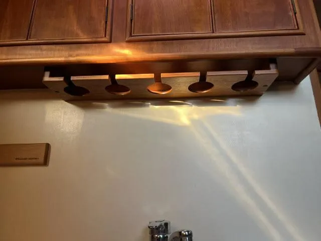 Lio Kai Yacht Photos Pics Wooden cabinet with under-shelf lighting in a 1999 Grand Banks Eastbay 38 yacht.