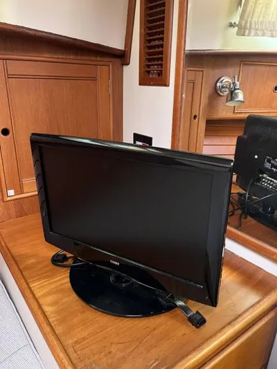 Lio Kai Yacht Photos Pics Flat-screen TV on wooden cabinet inside 1999 Grand Banks Eastbay 38 yacht.