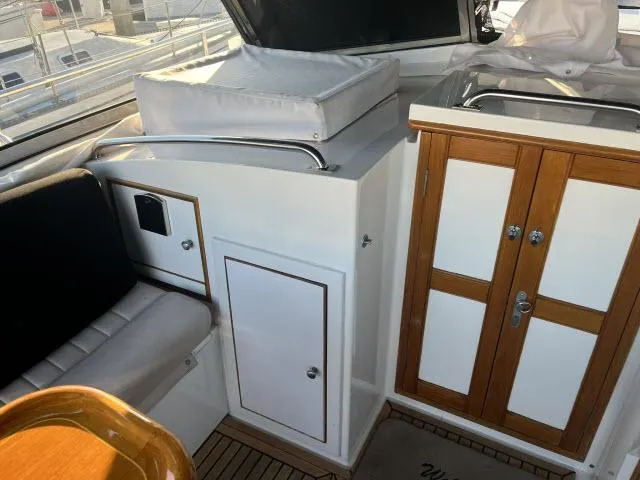 Lio Kai Yacht Photos Pics Interior of 1999 Grand Banks Eastbay 38 yacht with seating and storage cabinets.