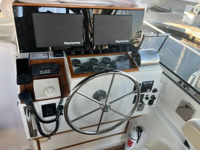 Lio Kai Yacht Photos Pics 1999 Grand Banks Eastbay 38 helm with Raymarine displays and steering wheel.