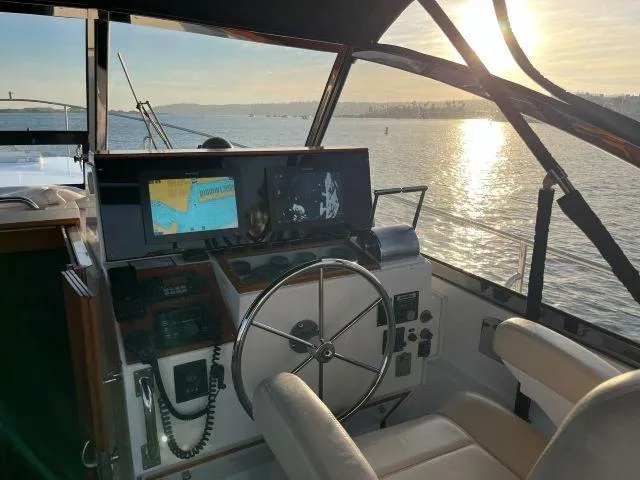 Lio Kai Yacht Photos Pics Interior view of 1999 Grand Banks Eastbay 38 yacht helm at sunset.