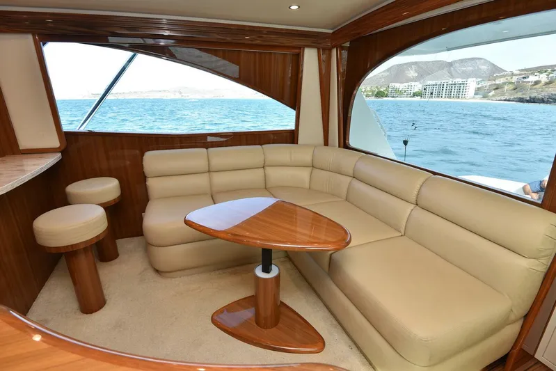 My Way Yacht Photos Pics Luxurious interior of 2019 Viking 44 Convertible yacht with beige leather seating and wooden accents.