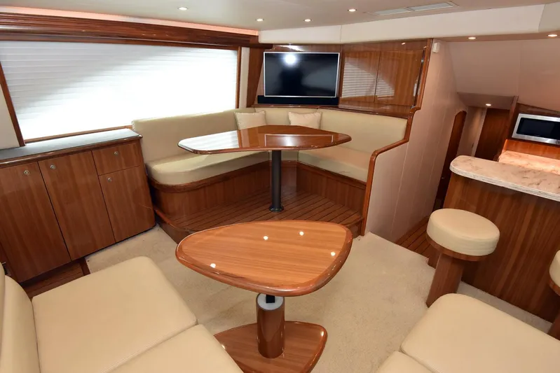 My Way Yacht Photos Pics Luxurious interior of 2019 Viking 44 Convertible yacht with elegant wood finish and seating area.
