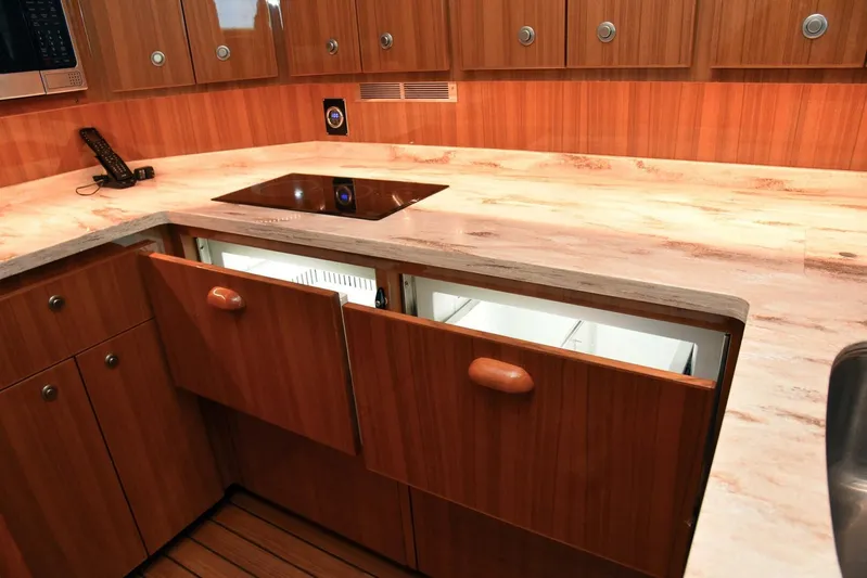 My Way Yacht Photos Pics Luxurious kitchen interior of 2019 Viking 44 Convertible yacht with wooden cabinets and modern appliances.