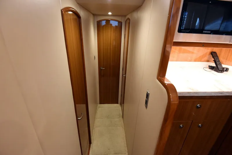 My Way Yacht Photos Pics Interior hallway of 2019 Viking 44 Convertible yacht with wooden doors and cabinetry.