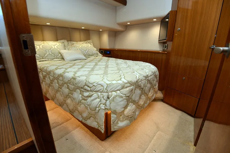 My Way Yacht Photos Pics Luxurious bedroom in 2019 Viking 44 Convertible yacht with elegant bedding and wood accents.