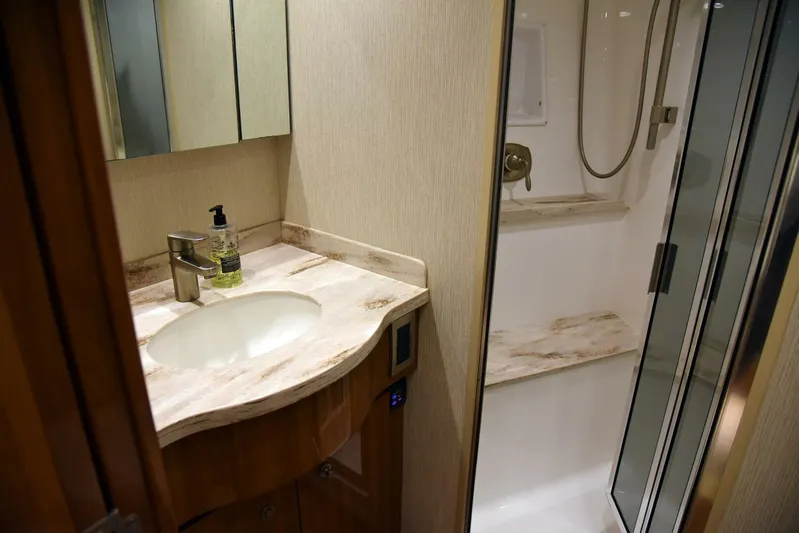 My Way Yacht Photos Pics Luxurious bathroom in 2019 Viking 44 Convertible yacht with modern sink and shower.