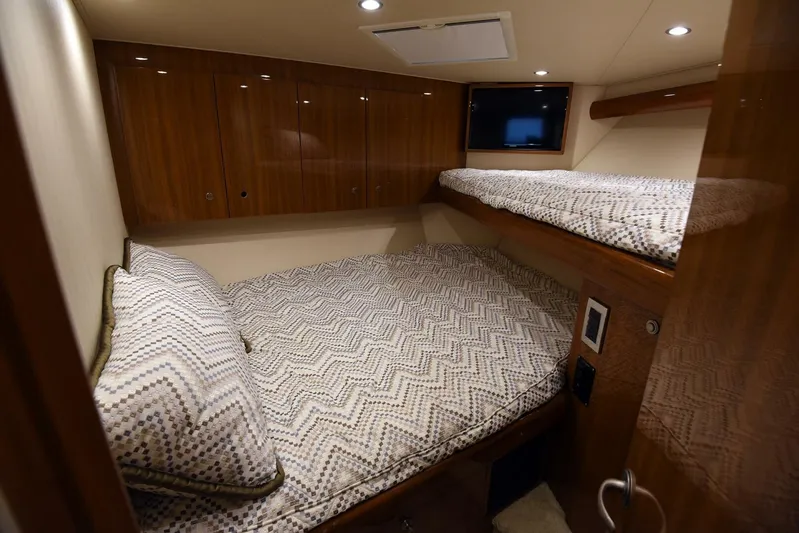 My Way Yacht Photos Pics Cozy cabin interior of 2019 Viking 44 Convertible yacht with wooden finishes and twin beds.