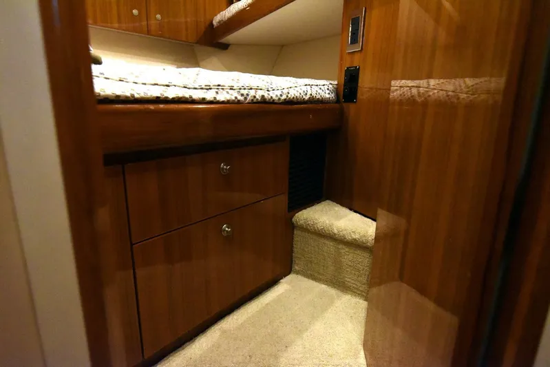 My Way Yacht Photos Pics 2019 Viking 44 Convertible cabin interior with wooden cabinetry and carpeted flooring.