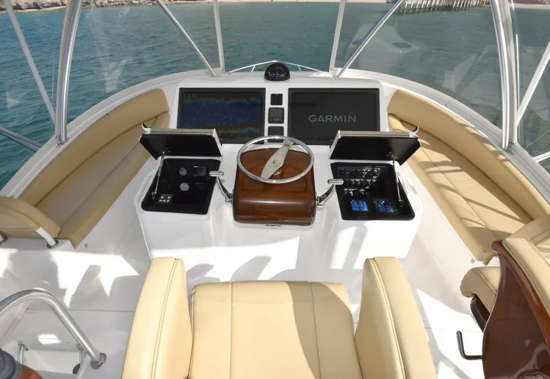 My Way Yacht Photos Pics 2019 Viking 44 Convertible helm with Garmin navigation, beige seating, and ocean view.