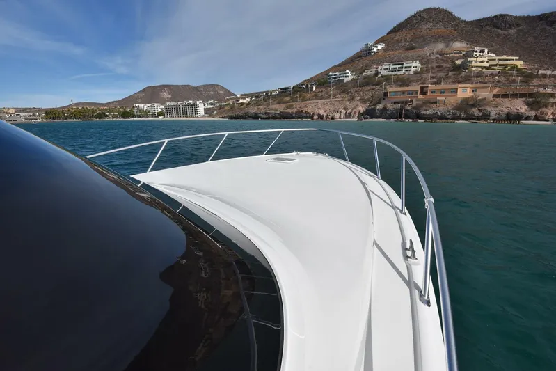 My Way Yacht Photos Pics 2019 Viking 44 Convertible yacht cruising near scenic coastline.