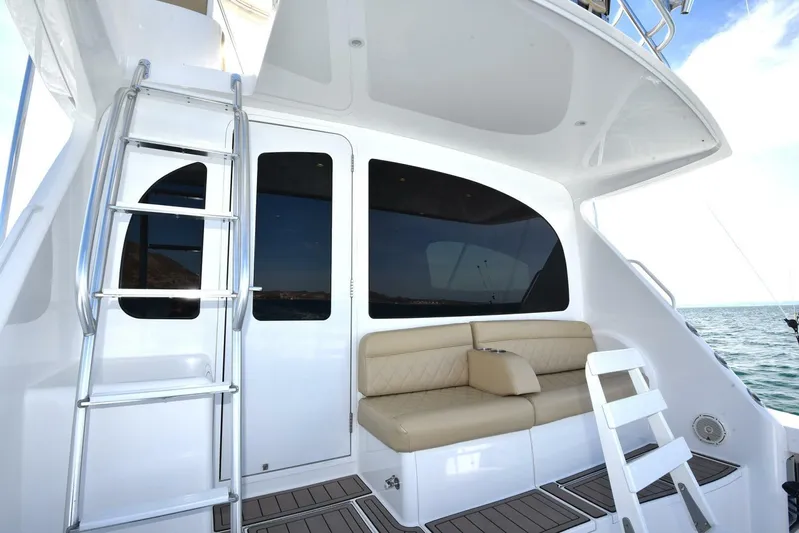 My Way Yacht Photos Pics 2019 Viking 44 Convertible yacht with seating and ladder on deck.