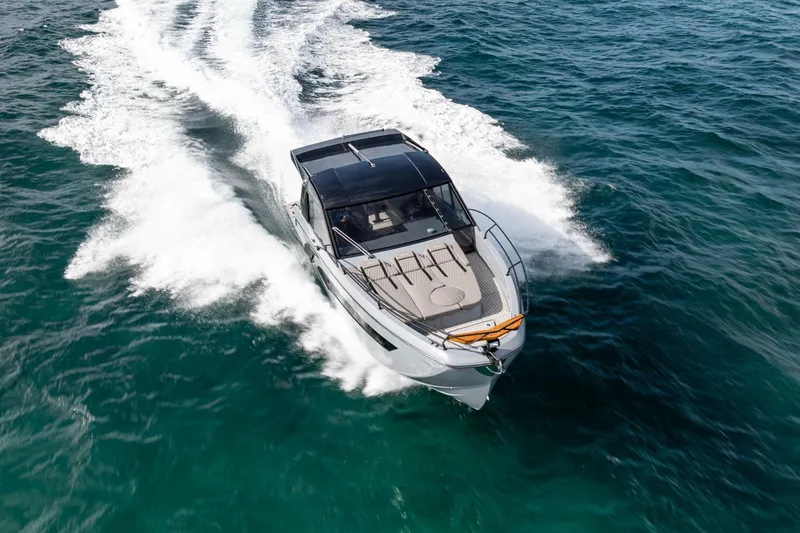  Yacht Photos Pics 2025 Hanover 387 yacht cruising on open water, creating a dynamic wake.