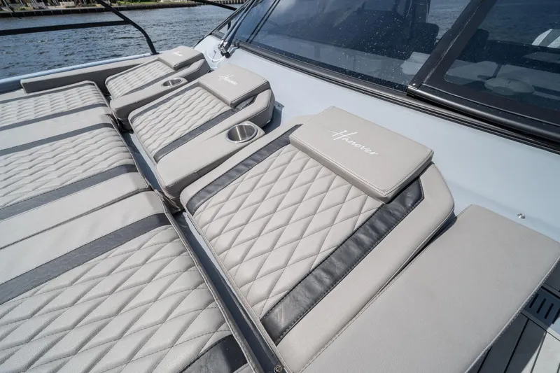  Yacht Photos Pics Luxurious seating on 2025 Hanover 387 boat with quilted design and cup holders.