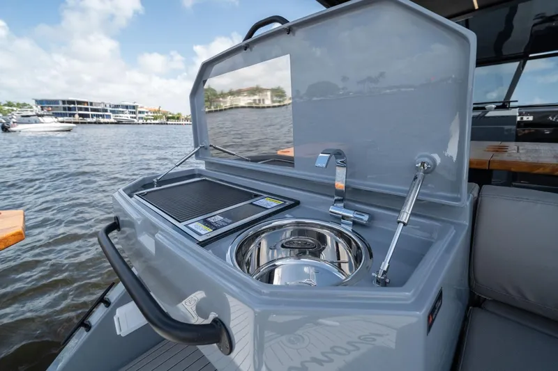  Yacht Photos Pics Outdoor kitchen on Hanover 387 boat, featuring sink and grill, 2025 model.