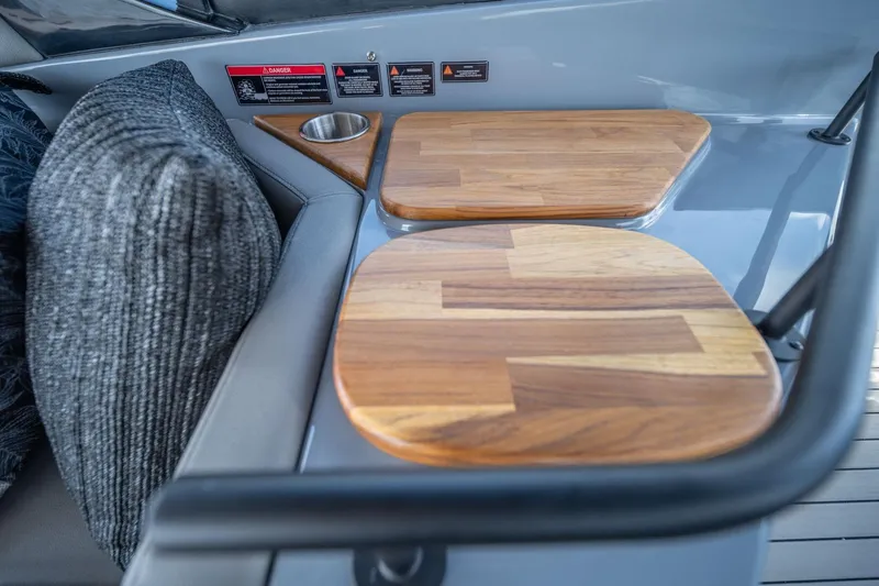  Yacht Photos Pics Interior of 2025 Hanover 387 boat with wooden accents and cushioned seating.