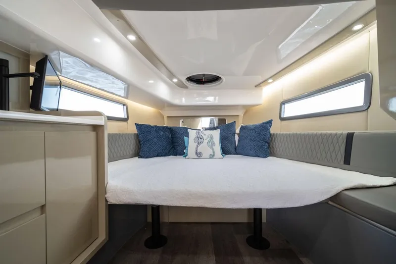  Yacht Photos Pics Luxurious interior of 2025 Hanover 387 boat with cozy bedding and modern design.
