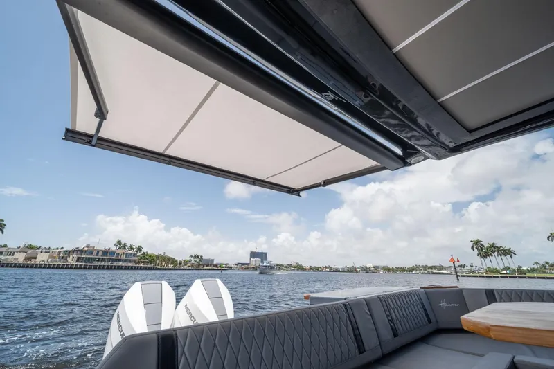  Yacht Photos Pics Luxurious Hanover 387 boat interior with awning, overlooking scenic waterfront, 2025 model.