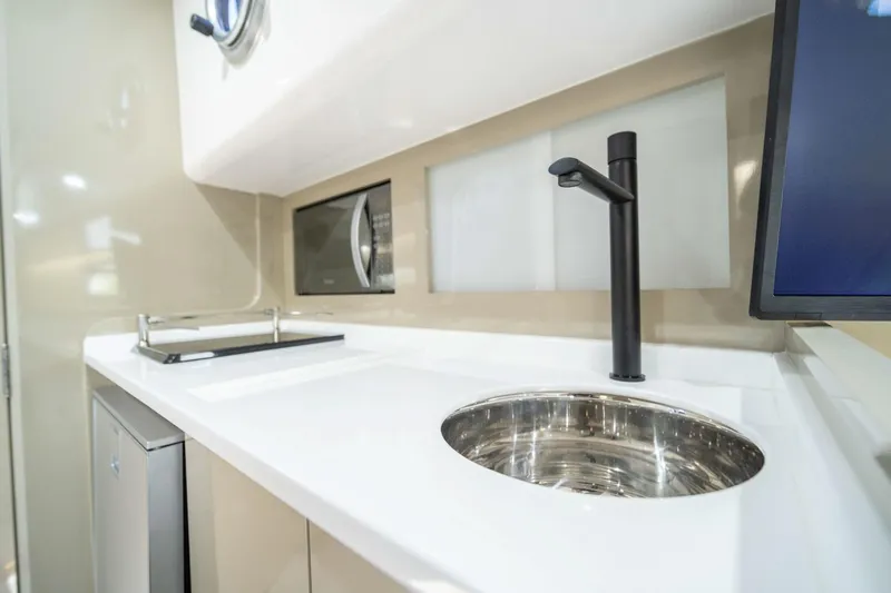  Yacht Photos Pics Modern kitchen area in 2025 Hanover 387, featuring sleek sink and microwave.