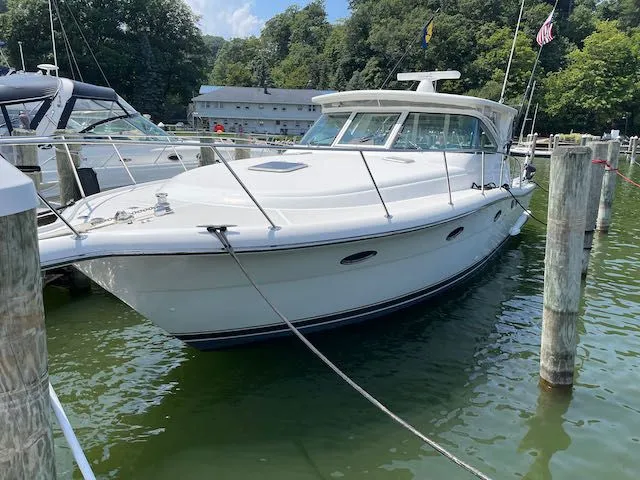  Yacht Photos Pics 2000 Tiara Yachts 38 Open docked in a marina, surrounded by water and trees.