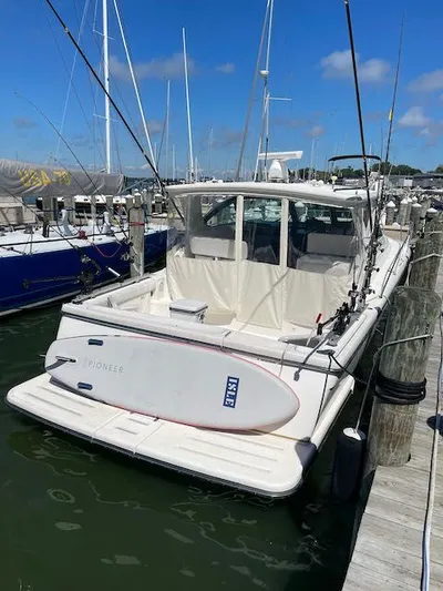  Yacht Photos Pics 2000 Tiara Yachts 38 Open docked, featuring fishing rods and paddleboard.