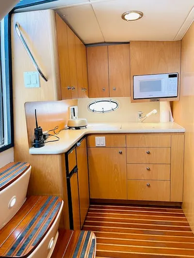  Yacht Photos Pics 2000 Tiara Yachts 38 Open interior kitchen with wood cabinets and modern appliances.