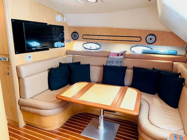  Yacht Photos Pics Interior of 2000 Tiara Yachts 38 Open with leather seating, wooden table, and mounted TV.