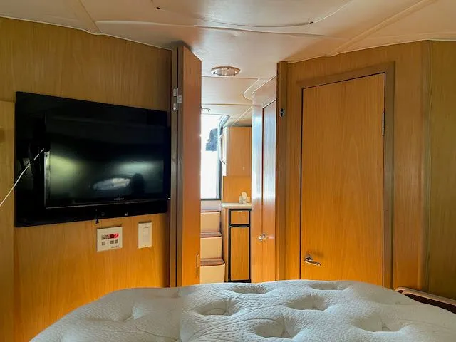  Yacht Photos Pics Interior of 2000 Tiara Yachts 38 Open with TV and wooden cabinetry.