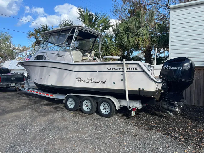  Yacht Photos Pics 2003 Grady-White Marlin 300 boat on trailer, parked outdoors, with Tohatsu engine.