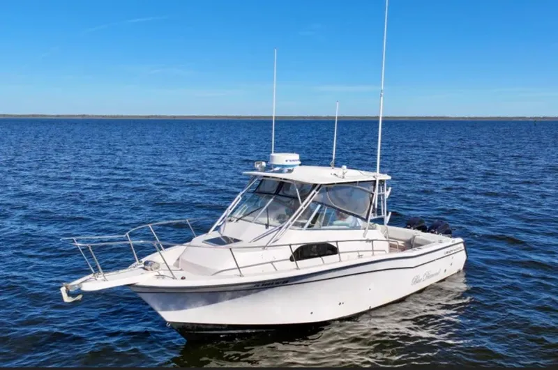  Yacht Photos Pics 2003 Grady-White Marlin 300 boat on open water under clear blue sky.