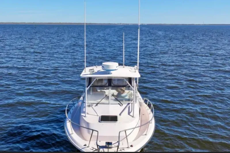  Yacht Photos Pics 2003 Grady-White Marlin 300 boat on open water, viewed from the front.