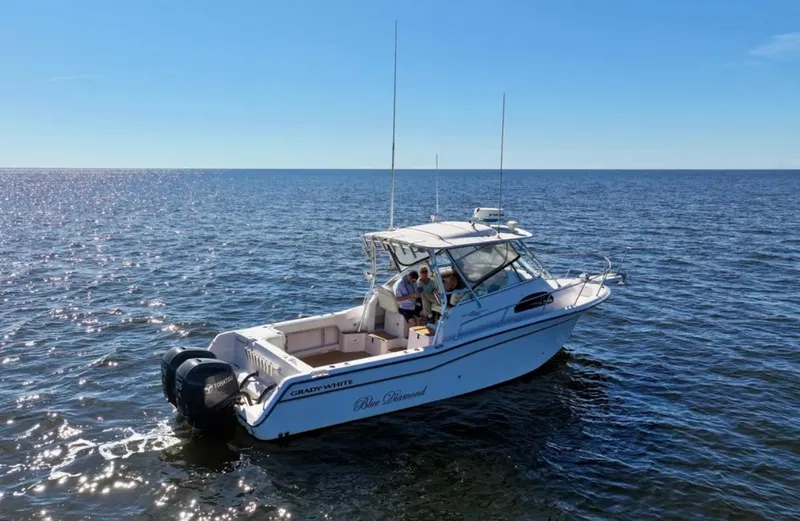  Yacht Photos Pics 2003 Grady-White Marlin 300 boat cruising on open water under clear blue skies.