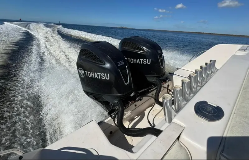  Yacht Photos Pics 2003 Grady-White Marlin 300 with dual Tohatsu engines cruising on open water.