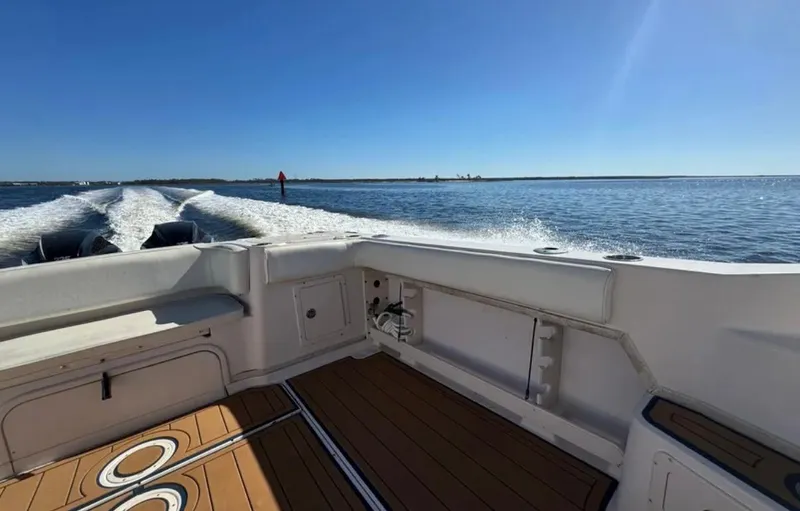  Yacht Photos Pics 2003 Grady-White Marlin 300 boat cruising on open water under clear blue sky.