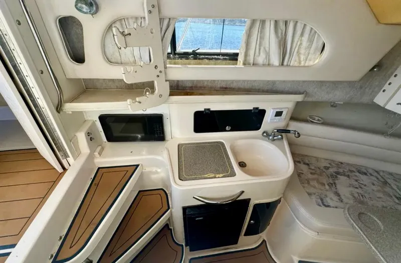  Yacht Photos Pics 2003 Grady-White Marlin 300 cabin interior with kitchenette, sink, and seating area.