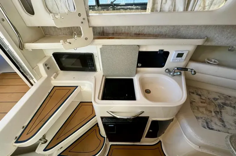  Yacht Photos Pics 2003 Grady-White Marlin 300 boat interior with kitchenette, sink, and microwave.