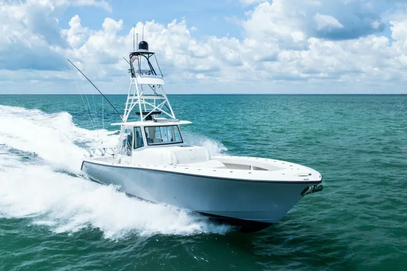 Fish Wish Yacht Photos Pics 2023 SeaVee 450z boat cruising on open ocean under a partly cloudy sky.
