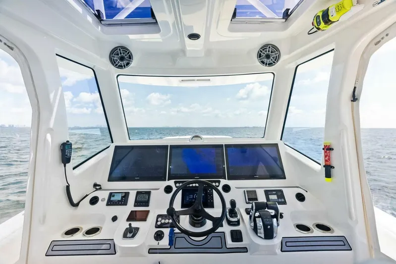 Fish Wish Yacht Photos Pics 2023 SeaVee 450z boat cockpit with advanced navigation systems and ocean view.