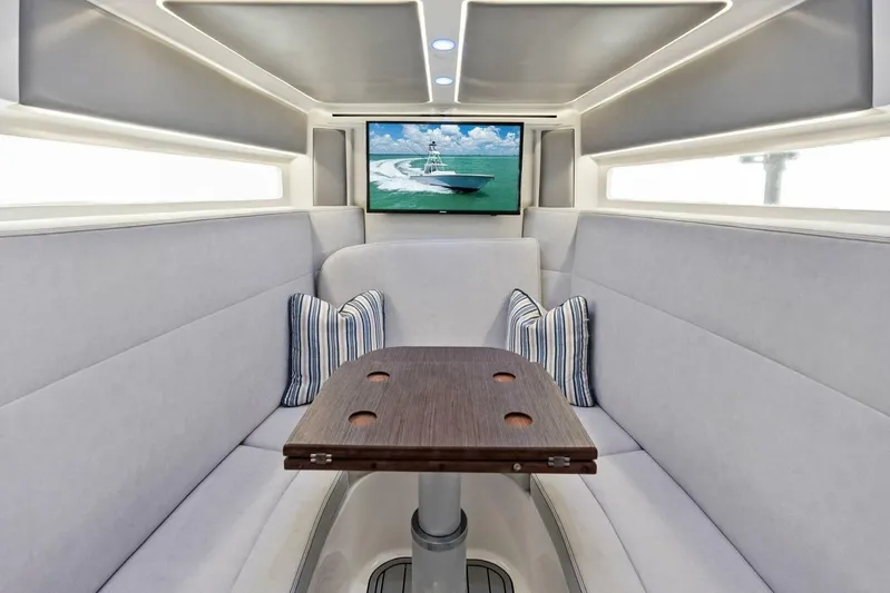 Fish Wish Yacht Photos Pics Interior of 2023 SeaVee 450z boat with cozy seating and a mounted TV.