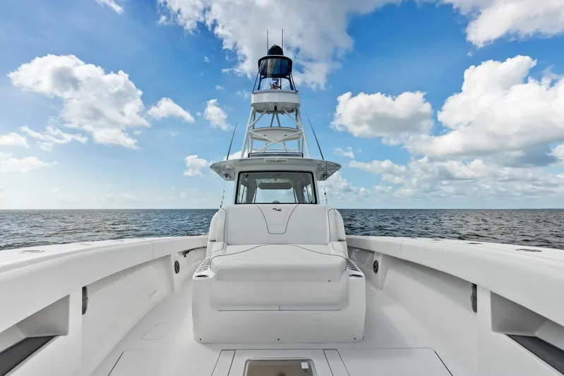 Fish Wish Yacht Photos Pics 2023 SeaVee 450z boat on open water under a blue sky with clouds.