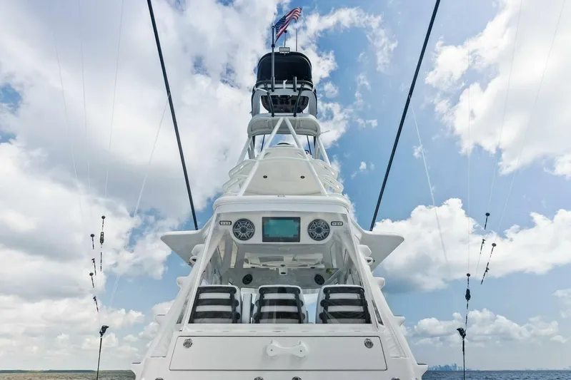 Fish Wish Yacht Photos Pics 2023 SeaVee 450z boat with tower against a cloudy sky backdrop.